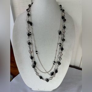 Two long black and silvertone bead necklaces